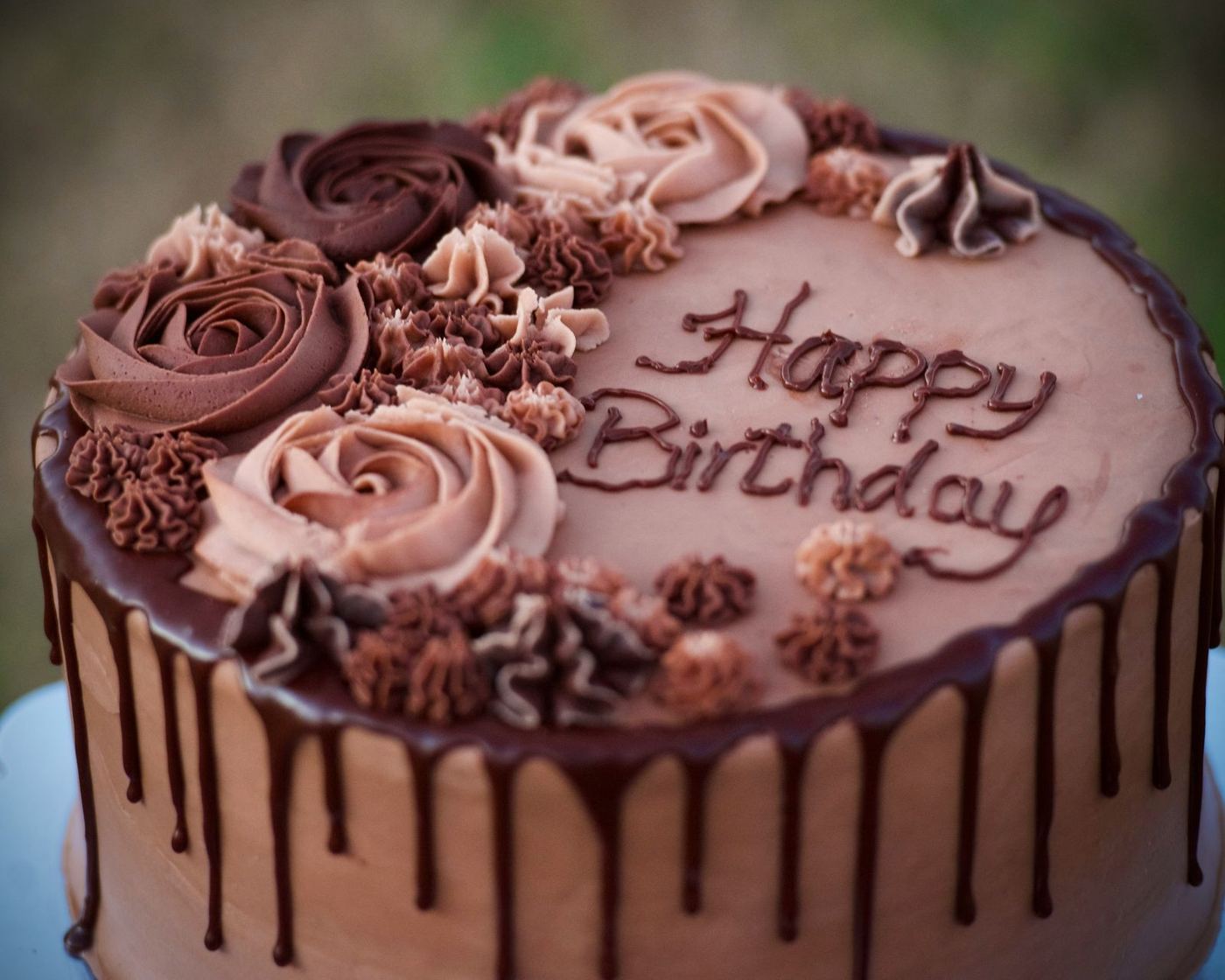 Chocolate birthday cake with piped rosettes