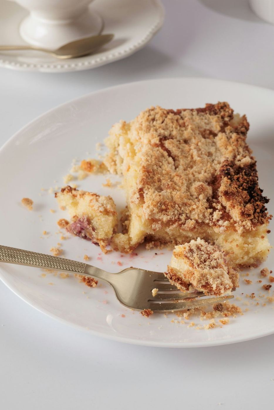 A slice of crumb-topped coffee cake on a plate