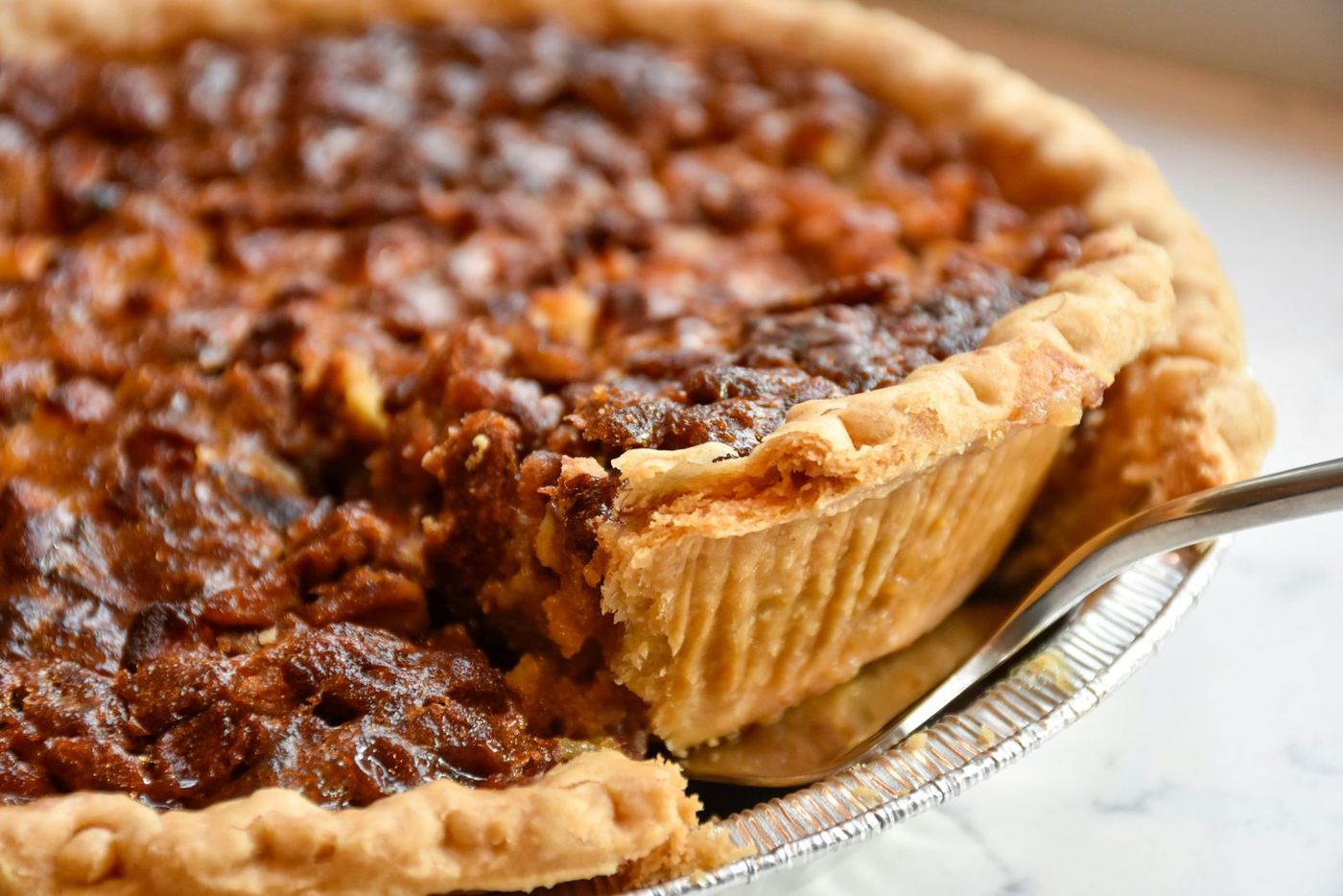Pecan pie with a slice lifted out
